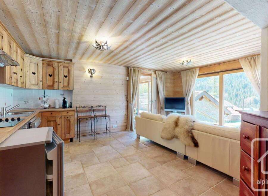 Discover the charm of this cozy property, featuring a beautifully designed kitchen and a comfortable living area.