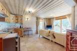 Discover the charm of this cozy property, featuring a beautifully designed kitchen and a comfortable living area.
