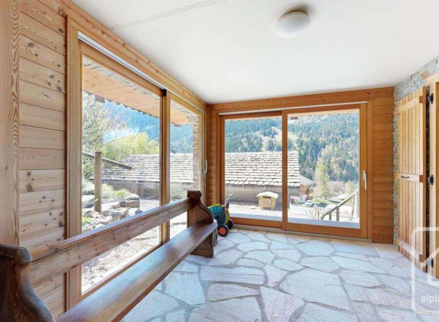 This stunning property boasts a sun-drenched interior with expansive windows framing breathtaking mountain views.