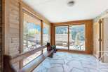 This stunning property boasts a sun-drenched interior with expansive windows framing breathtaking mountain views.