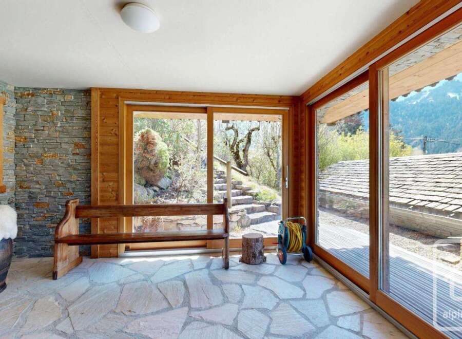 Experience the charm of this stunning property, featuring a beautifully designed interior with natural stone flooring and wooden accents.