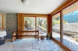 Experience the charm of this stunning property, featuring a beautifully designed interior with natural stone flooring and wooden accents.