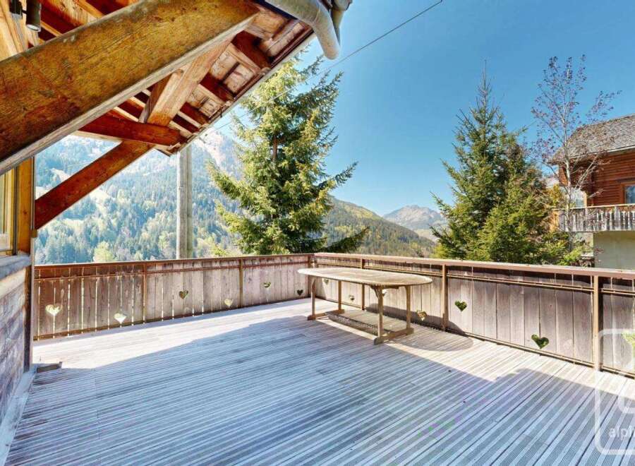 Enjoy breathtaking mountain views from this stunning wooden deck.