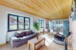 Discover the charm of this stunning property, featuring a beautifully designed living space with a cozy sofa and a rustic wooden coffee table.