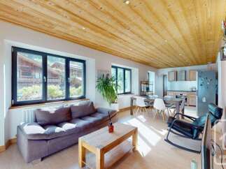 Discover the charm of this stunning property, featuring a beautifully designed living space with a cozy sofa and a rustic wooden coffee table.