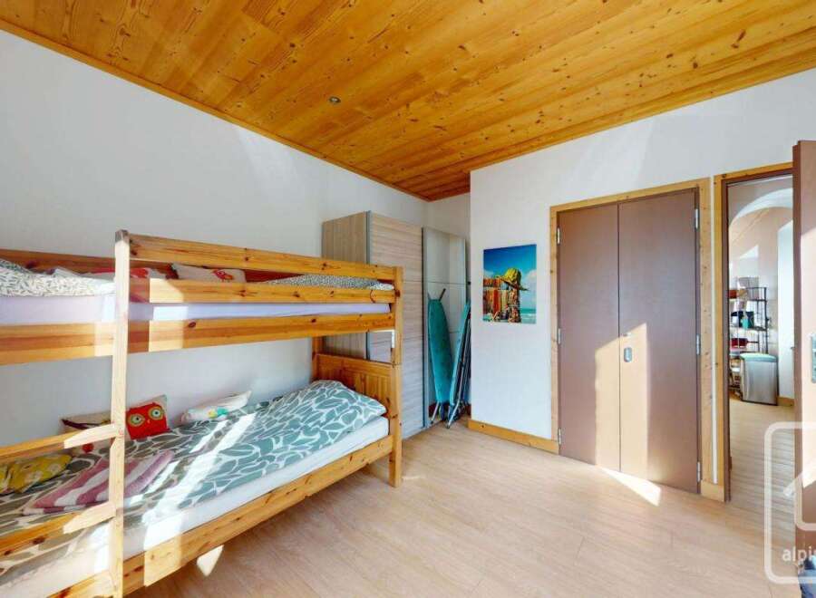 Discover this charming property featuring a cozy bunk bed setup, perfect for accommodating guests or family.