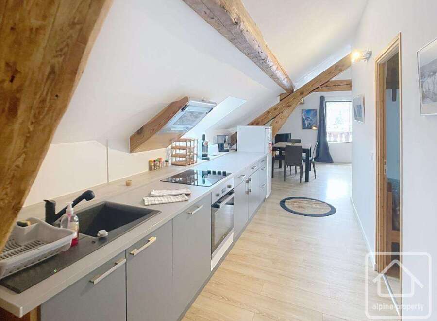This charming property boasts a modern kitchen with sleek cabinetry and integrated appliances, perfect for culinary enthusiasts.