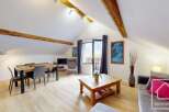 Discover the charm of this stunning property, featuring a spacious living area with exposed wooden beams and a modern design.