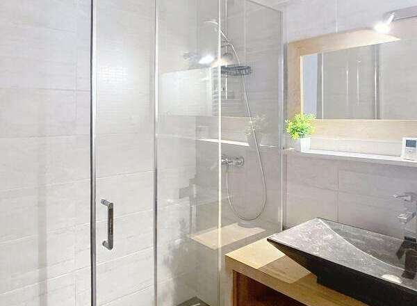 Step into a modern bathroom featuring a sleek glass shower enclosure.