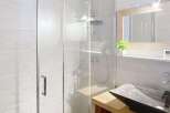 Step into a modern bathroom featuring a sleek glass shower enclosure.