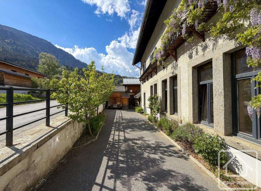 Discover the charm of this stunning property, showcasing a beautiful facade adorned with lush greenery.