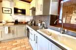 This charming kitchen boasts a cozy and inviting atmosphere, perfect for preparing delicious meals.