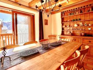 This charming dining room features a rustic wooden table and chairs, perfect for family gatherings.