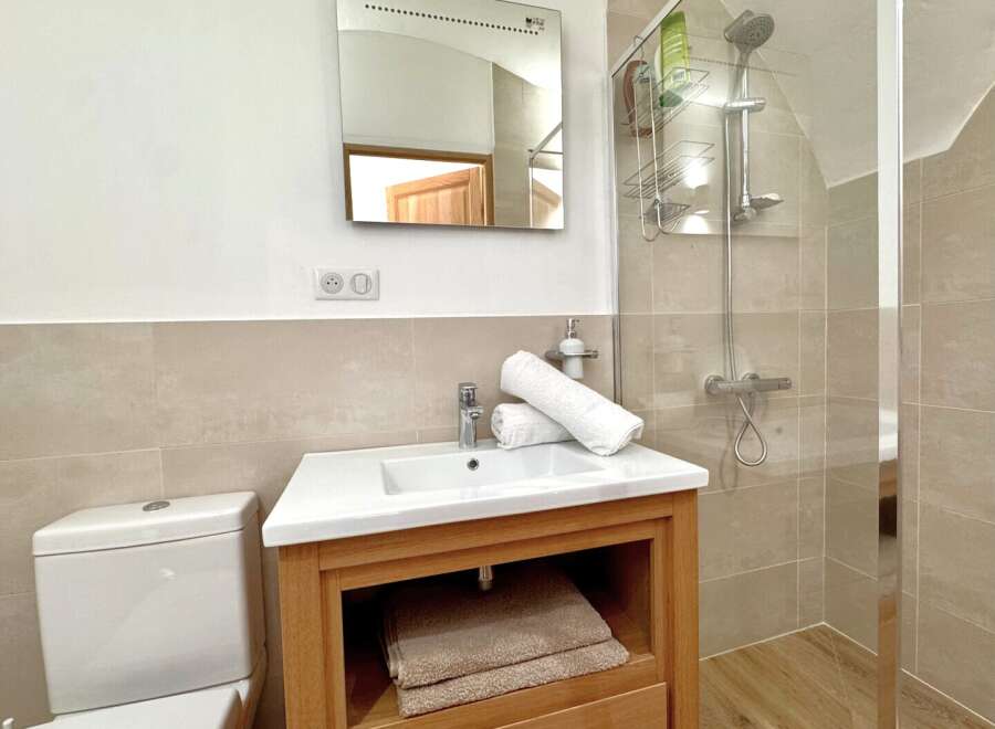 Step into this beautifully designed bathroom, featuring a modern vanity with ample storage and a pristine white sink.