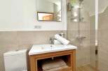 Step into this beautifully designed bathroom, featuring a modern vanity with ample storage and a pristine white sink.