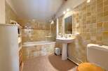 Step into this charming bathroom, featuring a classic design with tiled walls and a cozy atmosphere.