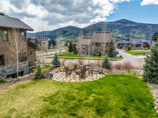 Discover luxury living in this stunning property, featuring a beautifully landscaped yard and a cozy outdoor seating area perfect for entertaining.