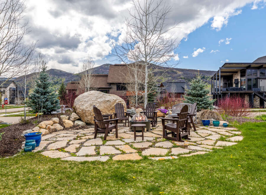 Enjoy the ultimate outdoor living experience with this stunning property! Featuring a cozy fire pit surrounded by comfortable seating, perfect for entertaining or relaxing.