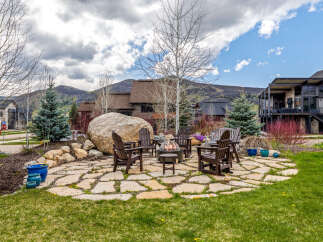 Enjoy the ultimate outdoor living experience with this stunning property! Featuring a cozy fire pit surrounded by comfortable seating, perfect for entertaining or relaxing.