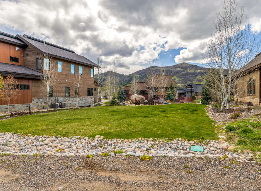 This stunning property boasts a modern design with beautiful wooden siding and large windows, offering ample natural light.