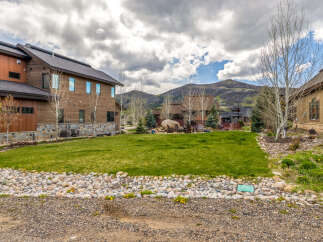 This stunning property boasts a modern design with beautiful wooden siding and large windows, offering ample natural light.
