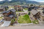 Discover luxury living in this stunning property featuring a meticulously landscaped yard and a cozy fire pit area, perfect for entertaining.