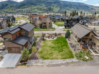 Discover luxury living in this stunning property featuring a meticulously landscaped yard and a cozy fire pit area, perfect for entertaining.