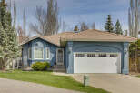 This charming home boasts a beautiful exterior with a blue stucco finish and a terracotta tile roof.