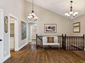 This stunning property boasts a beautifully designed interior with hardwood floors and elegant light fixtures.