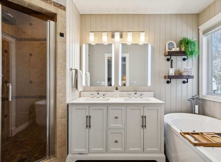 Step into luxury with this stunning bathroom, featuring a modern double vanity with ample storage and sleek fixtures.
