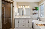 Step into luxury with this stunning bathroom, featuring a modern double vanity with ample storage and sleek fixtures.