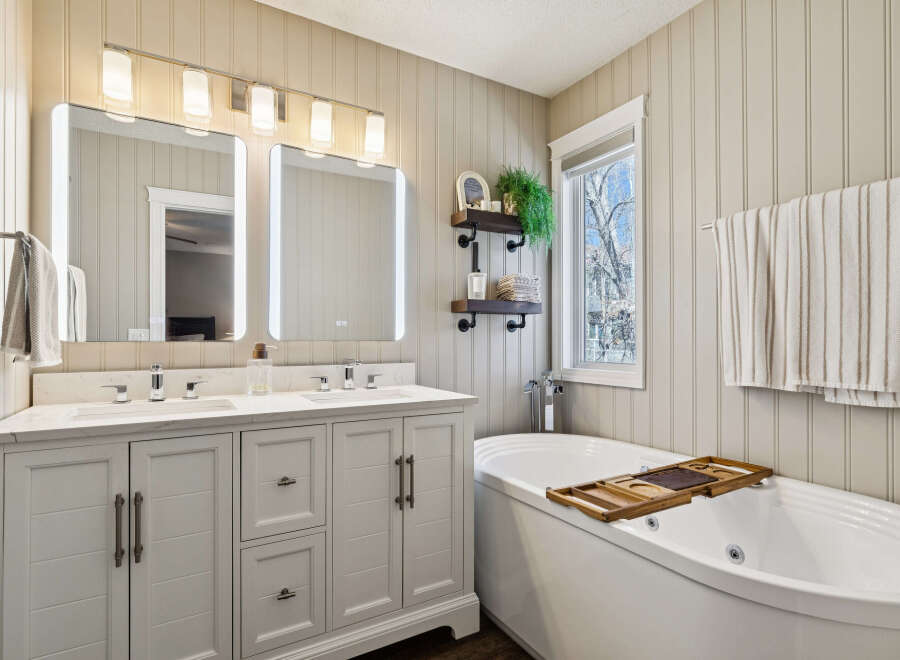 This stunning bathroom boasts a luxurious design with a modern vanity and a relaxing soaking tub.