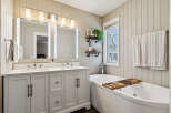 This stunning bathroom boasts a luxurious design with a modern vanity and a relaxing soaking tub.