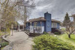 This stunning property features a beautifully designed backyard with a brick patio, perfect for outdoor entertaining.