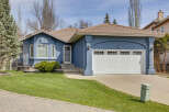 This charming home boasts a beautiful facade with a blue exterior and a welcoming front yard.