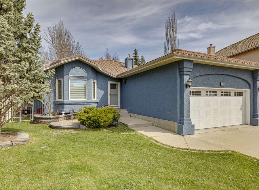 Discover this stunning property featuring a beautifully designed exterior with a charming blue facade and a welcoming front yard.