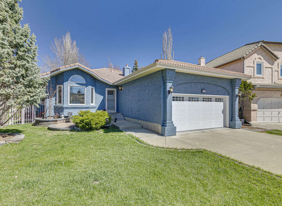 Discover this stunning property featuring a beautiful blue exterior and a well-maintained lawn.