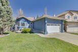 Discover this stunning property featuring a beautiful blue exterior and a well-maintained lawn.