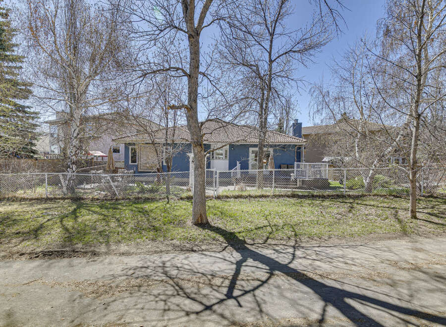 This charming property boasts a beautiful blue exterior and a well-maintained yard, perfect for outdoor enjoyment.