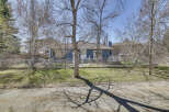 This charming property boasts a beautiful blue exterior and a well-maintained yard, perfect for outdoor enjoyment.