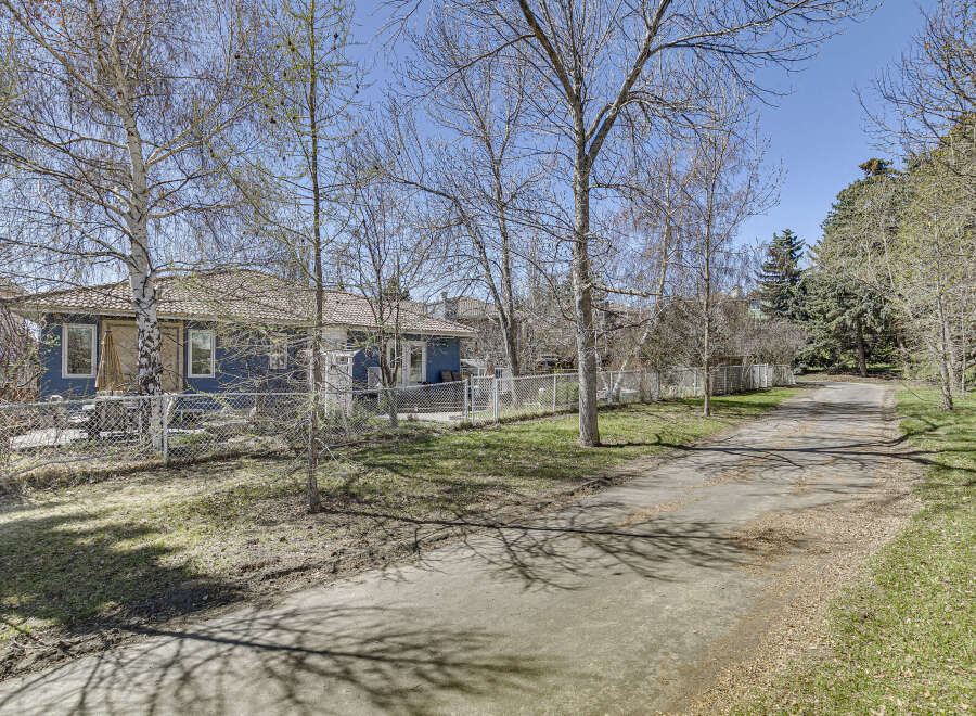 Discover this charming property featuring a cozy blue house with a welcoming exterior.