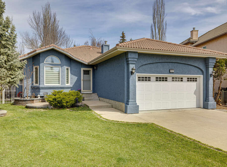 Discover this stunning property featuring a beautifully designed exterior with a charming blue facade and a welcoming front yard.