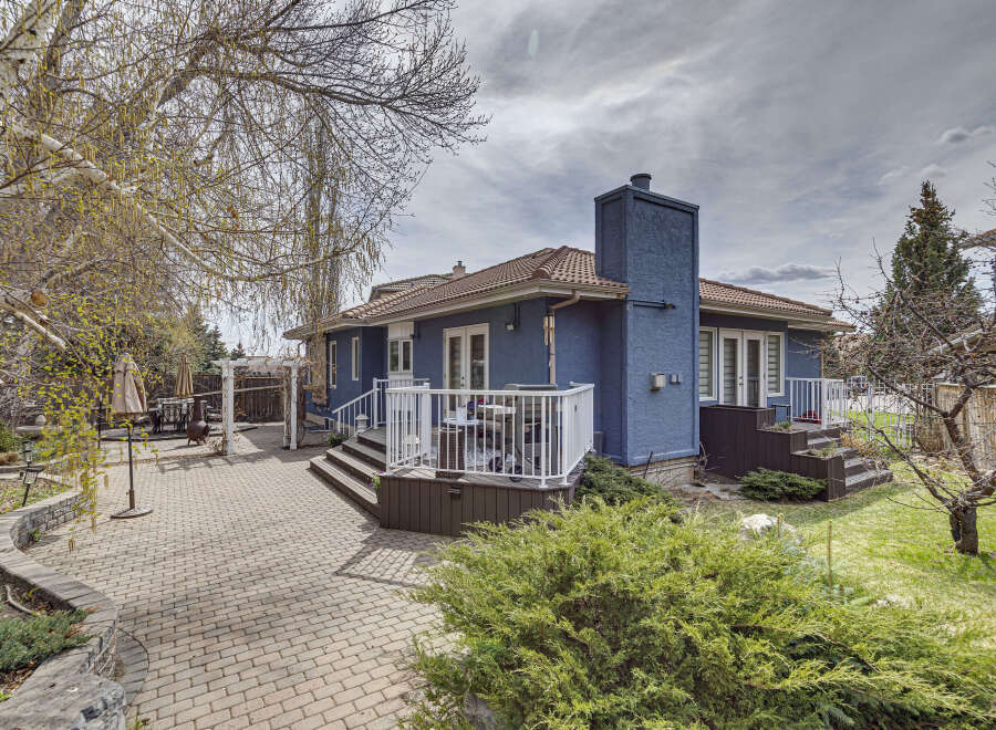 This stunning property features a beautifully designed backyard with a brick patio, perfect for outdoor entertaining.