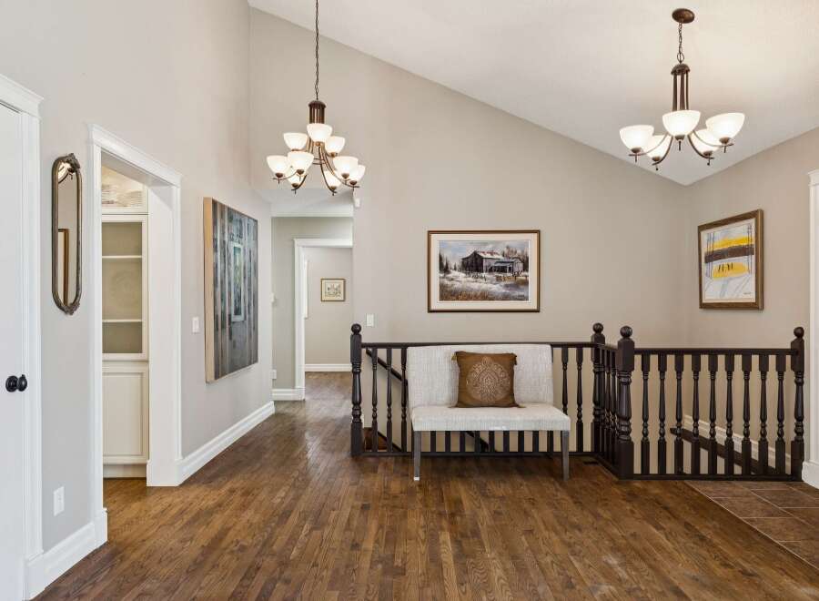 This stunning property boasts a beautifully designed interior with hardwood floors and elegant light fixtures.