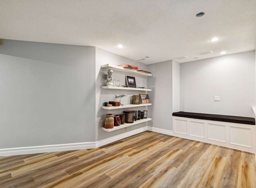 This inviting space features a cozy built-in bench, perfect for relaxation.