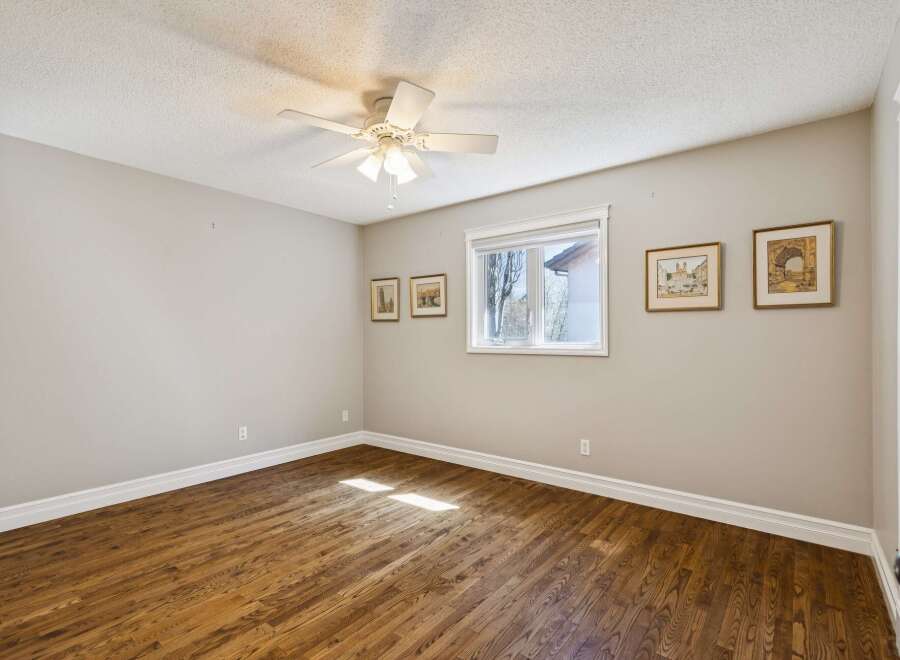 Step into this inviting bedroom, featuring warm hardwood floors and a neutral color palette that creates a sense of calm.