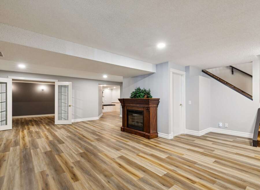 Step into this inviting space featuring a cozy fireplace and elegant hardwood floors.