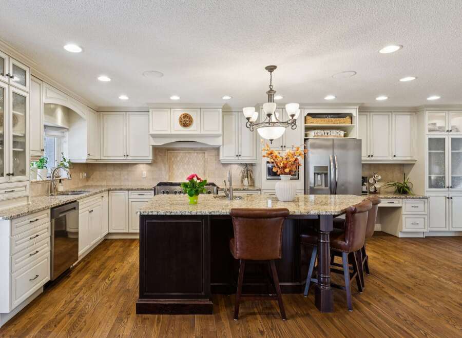 This stunning kitchen boasts a spacious island with seating, perfect for entertaining or casual dining.