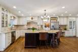 This stunning kitchen boasts a spacious island with seating, perfect for entertaining or casual dining.