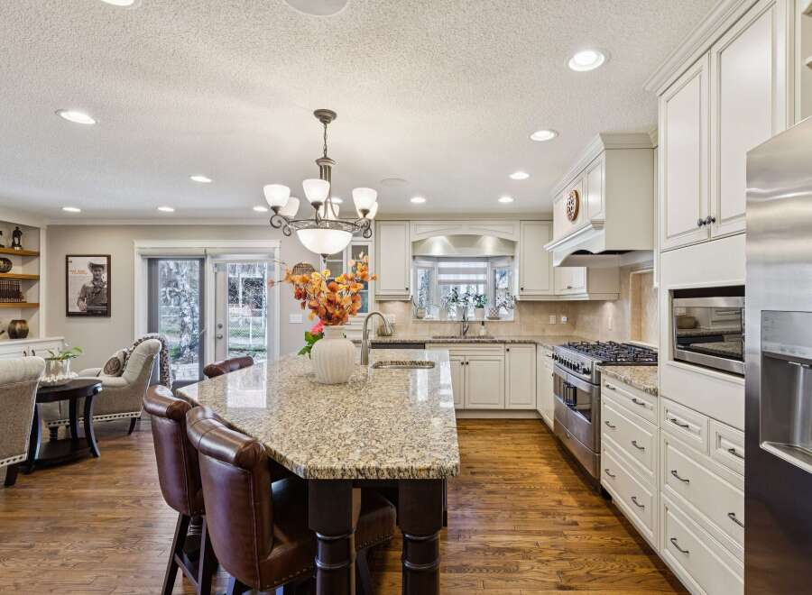 Step into this stunning kitchen, the heart of the home, featuring a spacious island with seating, perfect for entertaining.